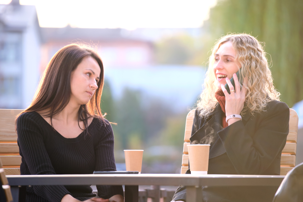 Sad woman being ignored by her friend